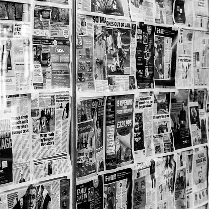 Kingston Upon Thames, London UK, April 7 2021, Printed Newspapers Covering A Closed Retail Shop Window During Coronavirus Covid-19 Lockdown