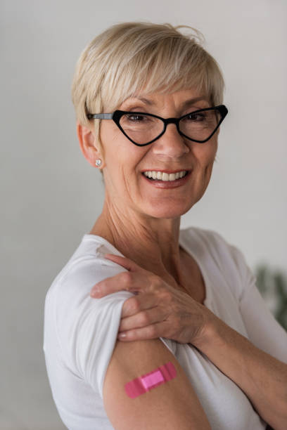 istock Portrait of a beautiful elderly lady just got vaccinated, showing a patch 1317842515