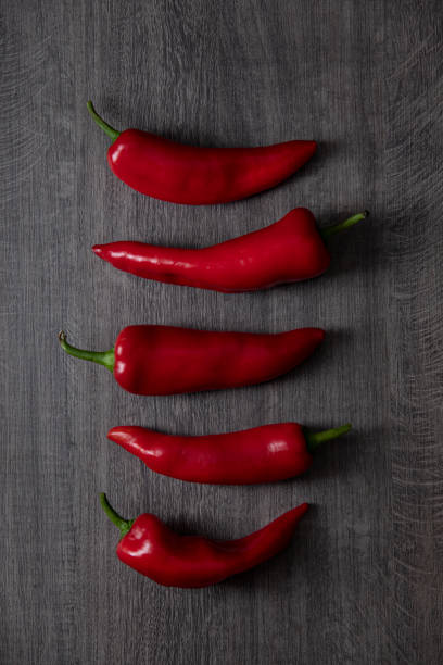 istock Red peppers on Dark Wooden Table 1317843419
