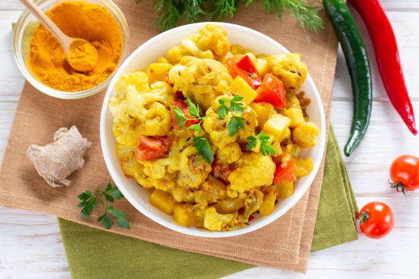 istock Curry roasted cauliflower - vegetarian vegetable dish, selective focus. Top view 1317843490