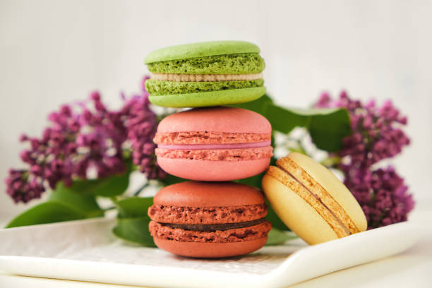istock Cup of coffee with macaroons on a table with flowers 1317846605