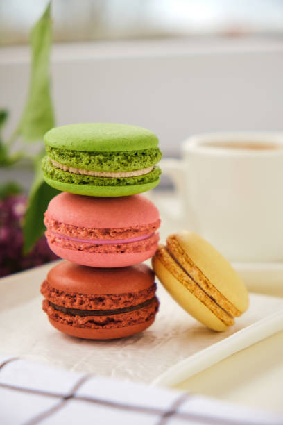 istock Cup of coffee with macaroons on a table with flowers 1317846622