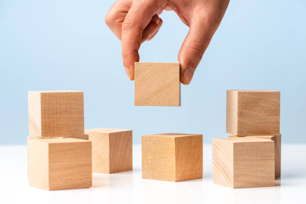 istock Businessman hand and Wood Blocks on blue background 1317846822