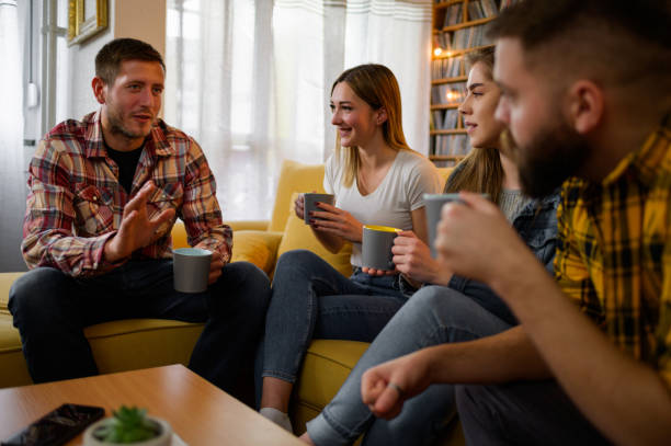 istock Friends drinking coffee and having fun while at the house party 1317851241