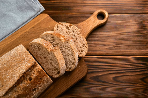 istock Fresh bread and slices on cutting board 1317851329
