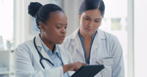 istock Shot of two doctors using a digital tablet together in a hospital 1317852143