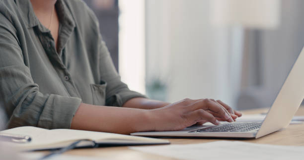 istock Closeup shot of a woman using a laptop while working from home 1317853423