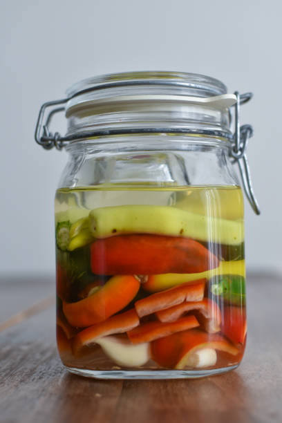 istock Homemade food: different kind of peppers ready to ferment in a mason jar 1317856300