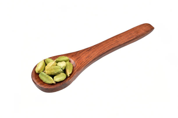 istock Cardamom in wooden spoon isolated on white background with clipping path 1317859163