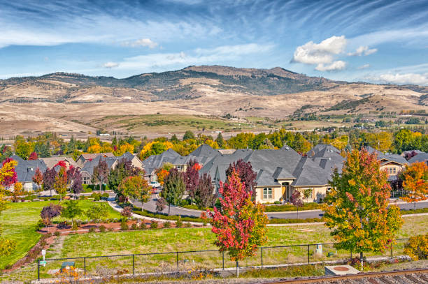 Ashland, Oregon - USA: This housing development in Ashland Oregon located above a freeway with full view of the mountains in the background and on this October day with a large variety of colors in the trees makes this site a very pleasant view.