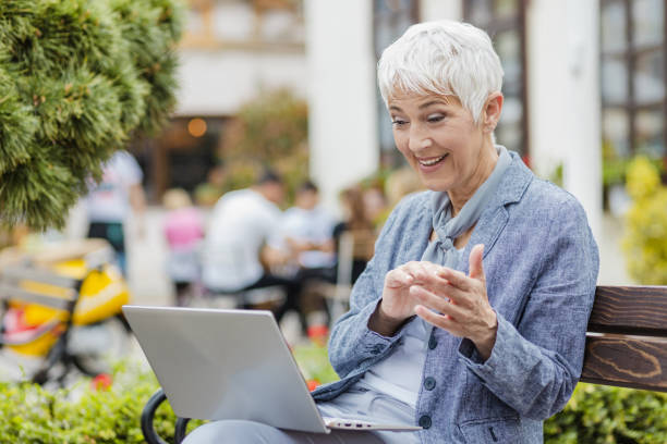 istock Senior woman is using laptop and communicating on the video call 1317861049