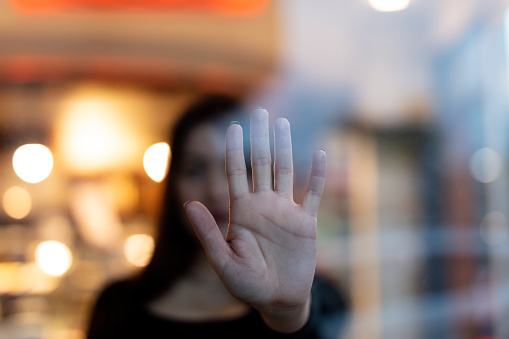 A woman showing gesture STOP. Violence against women concept