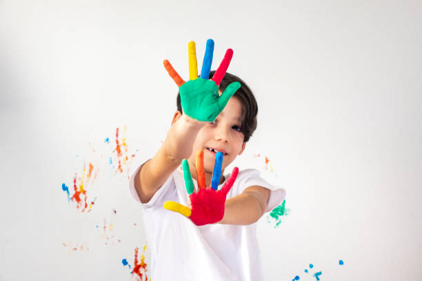 istock Boy Showing Colorful Paint on His Hands 1317865343
