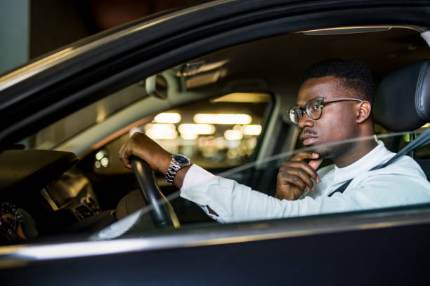 istock African American businessman driving a car. 1317866826