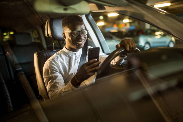 istock African American businessman texting and driving. 1317866949