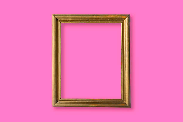 istock Gold photo frame in a pink wall 1317870433