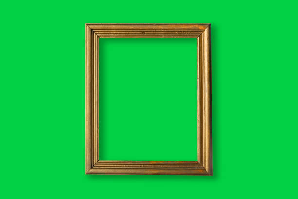 istock Gold photo frame in a green wall 1317870514