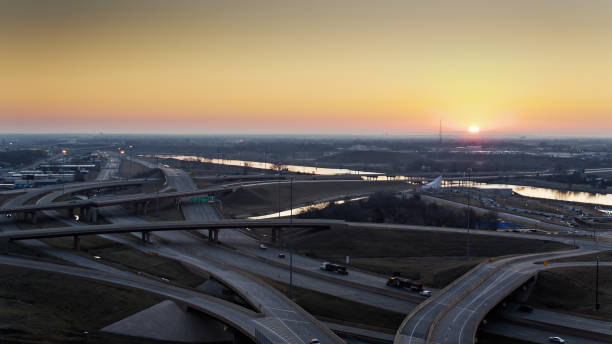 istock Sun Coming Up Over Freeway Interchange - Aerial 1317870584
