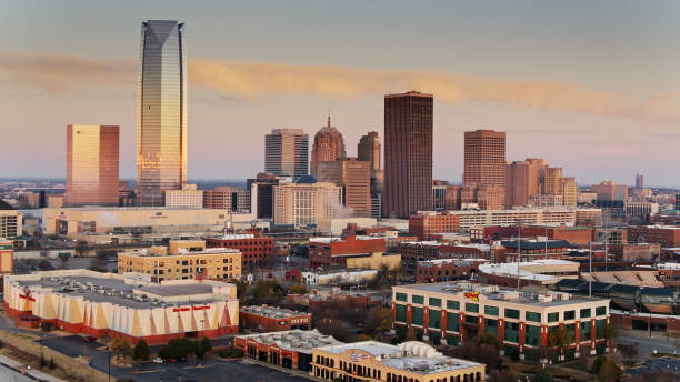 bricktown und central business district bei sonnenaufgang in oklahoma city - aerial - oklahoma city oklahoma city urban scene stock-fotos und bilder