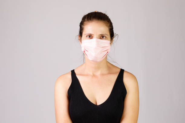 istock Serious woman wearing protective face mask 1317879174