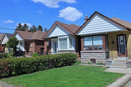 Row of small brick bungalow houses with gables