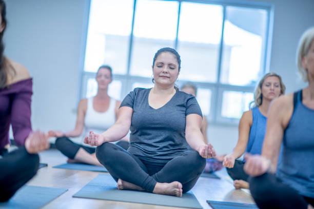 istock Women meditating in the studio 1317882661
