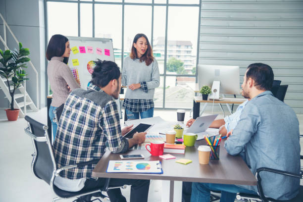 istock Creative design office center working teamwork. Happy business people partner plan strategy organization research people together at diversity office using laptop, smartphone company conference room 1317883888