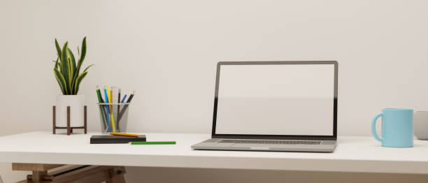 istock Simple working space with laptop, stationery, mug and plant pot on the table, 3D rendering 1317889240