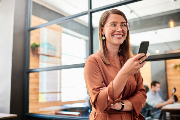 istock Shot of a young businesswoman using a smartphone in a modern office 1317890708