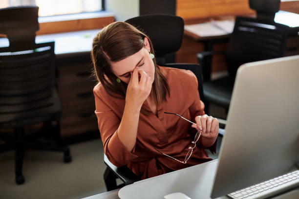 istock Shot of a young businesswoman looking stressed while using a computer in a modern office 1317890995