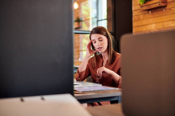 istock Shot of a young businesswoman looking stressed while using a computer in a modern office 1317891000