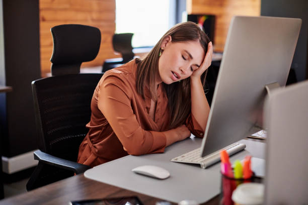 istock Shot of a young businesswoman looking stressed while using a computer in a modern office 1317891009