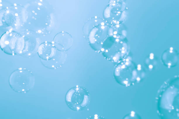 istock Beautiful Shiny Transparent Soap Bubbles Float on Blue Background. 1317898262