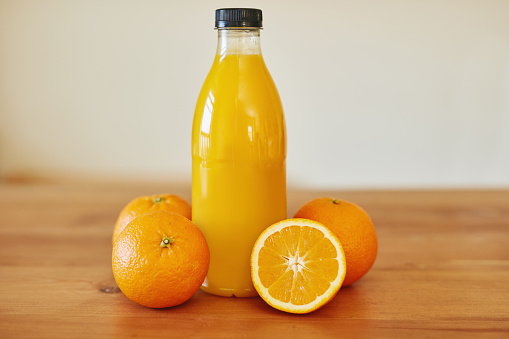 Vitamin C bottle mockup with fresh orange, natural bio supplement