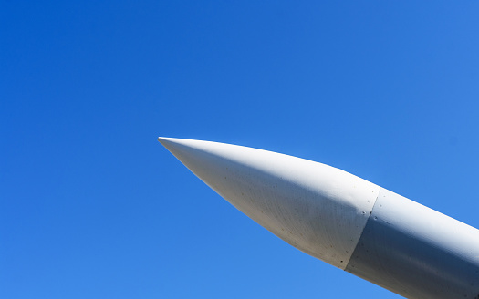 Missile, Rocket with a warhead pointing at the blue sky in sunlight. Close-up.