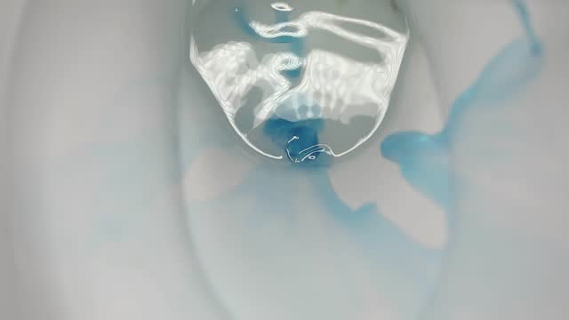 the process of washing the toilet with an antibacterial cleaner, close-up, slow motion