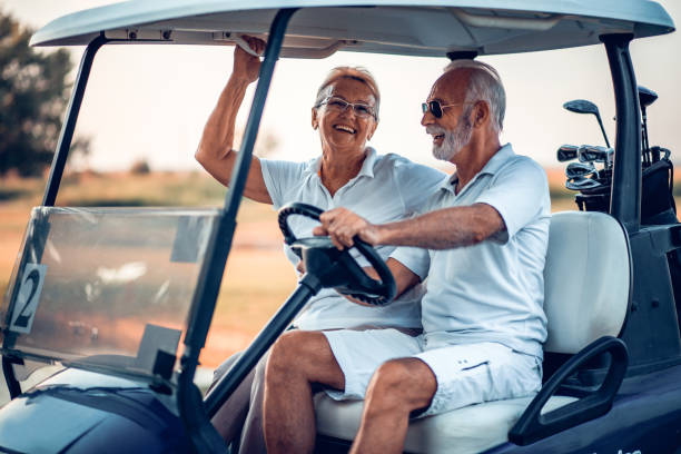 istock Elderly golf couple rides in a golf cart. 1317903515
