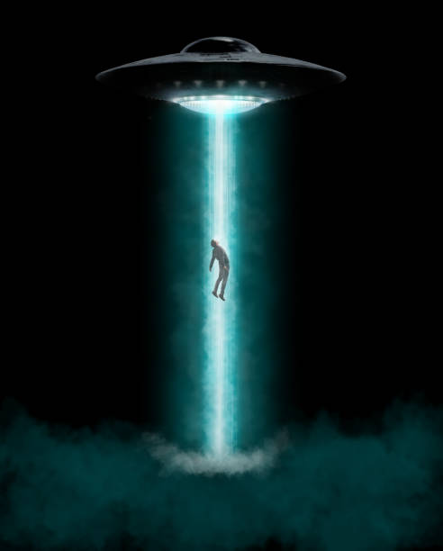 istock Man being abducted by UFO - alien abduction concept 1317903586