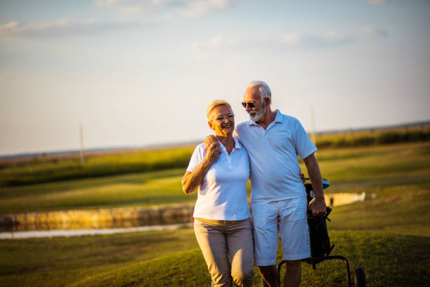 istock Senior golfers talking and walking on golf course. 1317903620