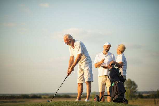 istock Three seniors golfers on golf court. Man playing a golf. 1317904242