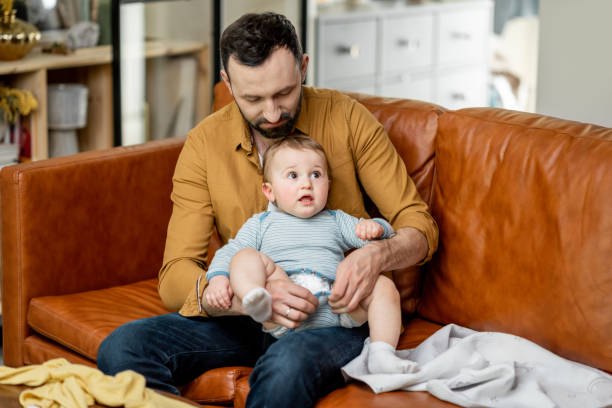 istock Father changing diaper to his baby son alone at home 1317904848