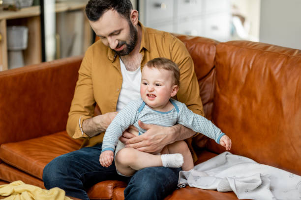 istock Middle aged dad carrying and playing with newborn baby 1317905563