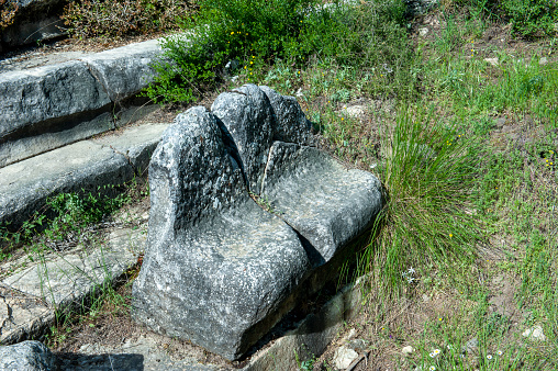 Ancient stone rotary mill for hand-grinding a grain into flour. Old hand-driven mill grinding wheat