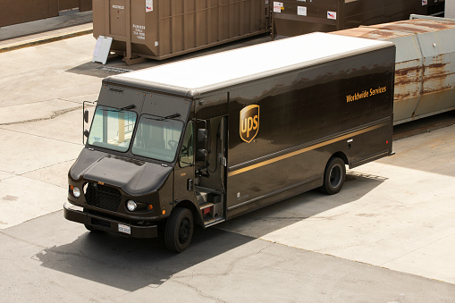 Brea, California, USA - May 1, 2021: Light shines on a UPS delivery truck.