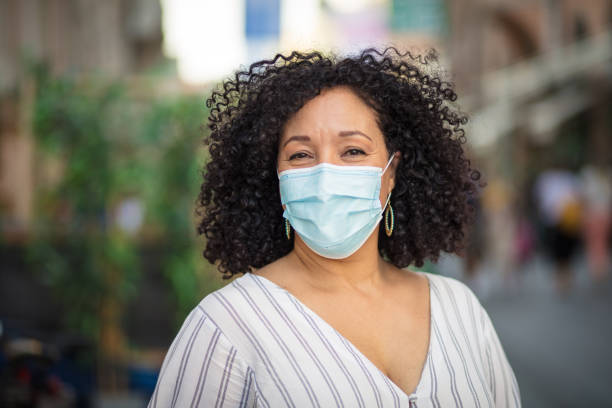 istock Woman with protective mask on face walking trough city. 1317907598