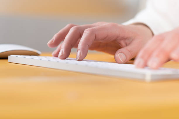 istock Office worker checks email while sitting at a wooden table. 1317908860
