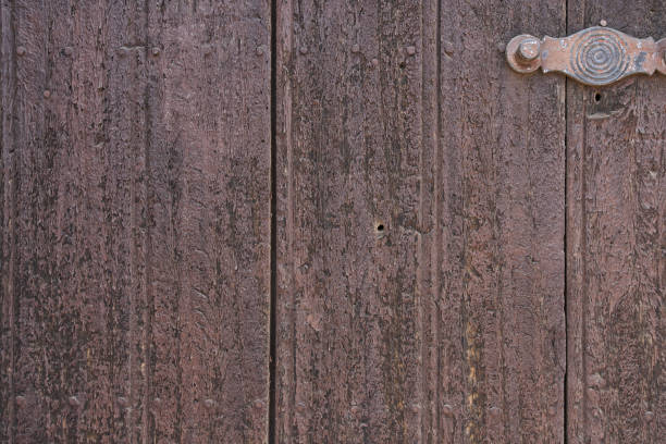 istock Old wooden texture of windows and doors weathered by time with cracks and rusty nails 1317909047