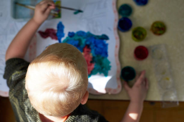 istock A three-year-old boy paints with gouache coloring. 1317911350