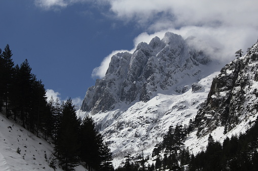 View of a snow covered peak of the Corsican mountain riange above the Restonica Valley.