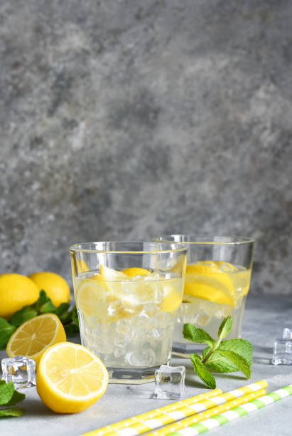 istock Cold lemonade with lemon, mint and ice on a concrete background. 1317914931